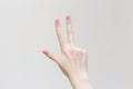 WomanÃ¢â¬â¢s hand shows up three fingers as number three on white background Royalty Free Stock Photo